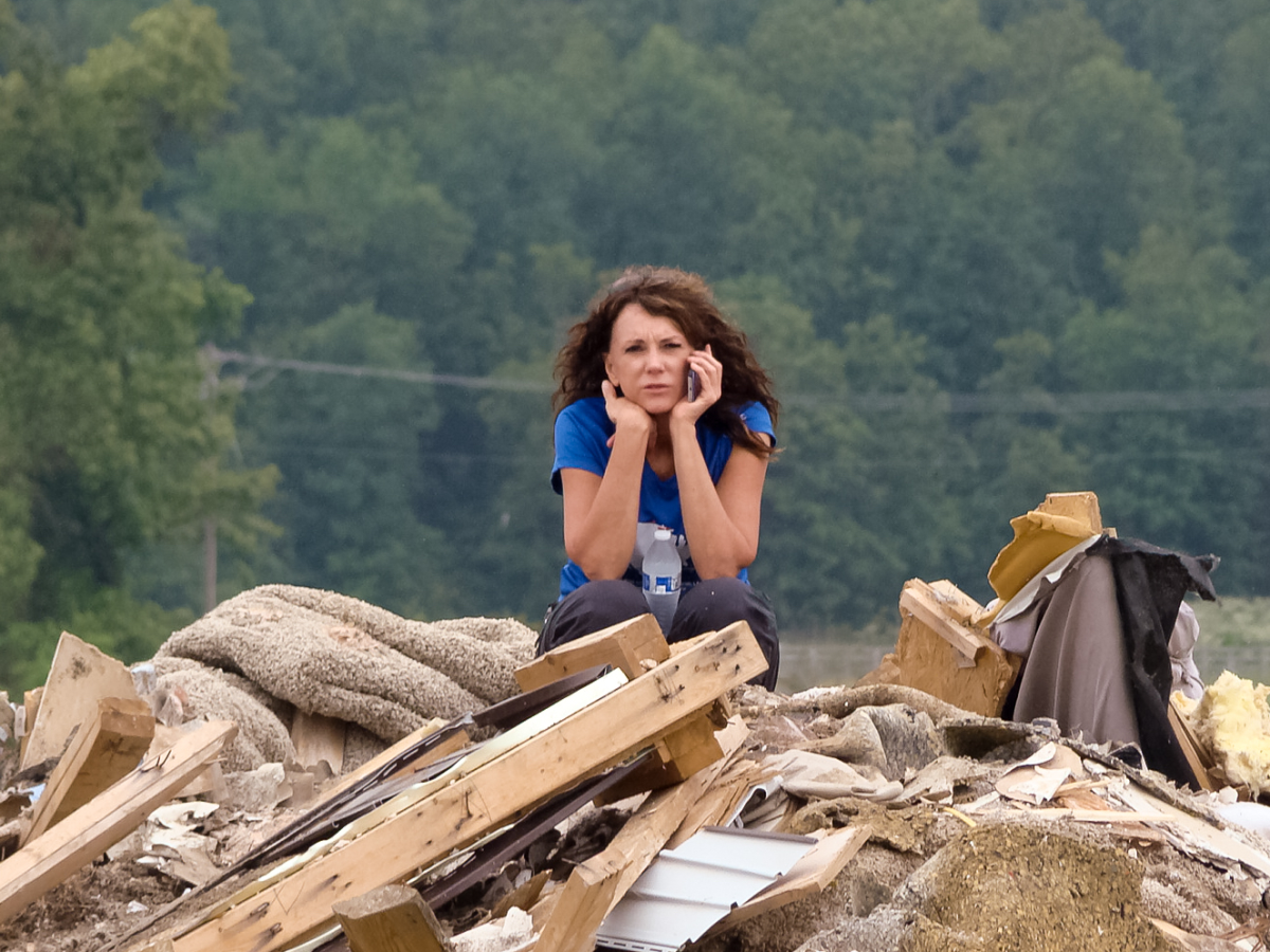 Rebecca Thomley on top of rubble