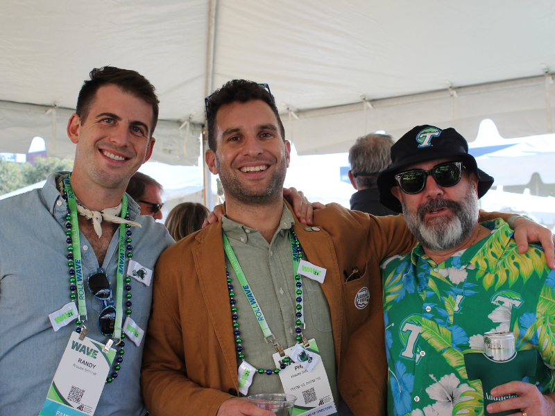 Alumnus poses with career services director at tailgate