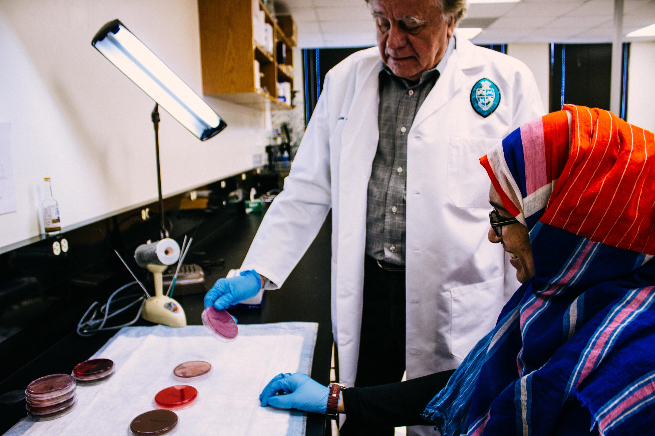 Preston Marx working with student in lab