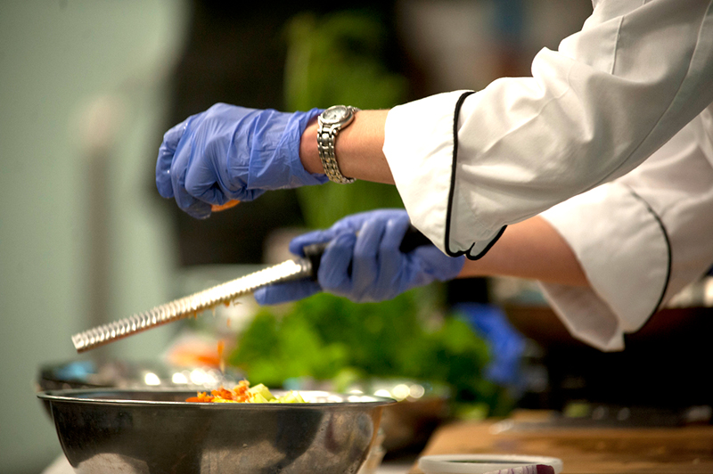 Tulane Culinary Medicine program chef assembling a salad`