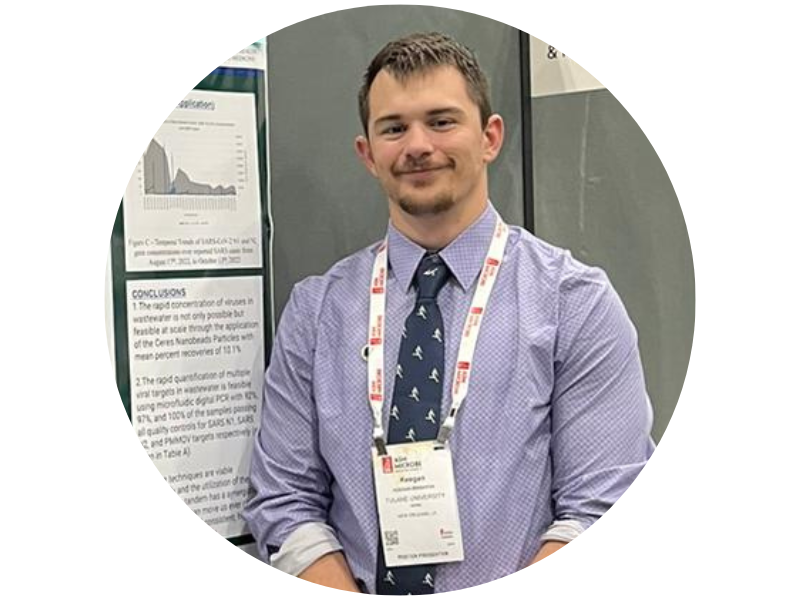 Keegan Brighton, stadning next to a poster at a poster session