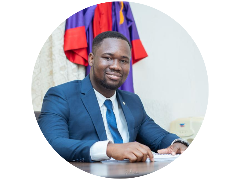Codjo Dadje sitting at a desk smiling