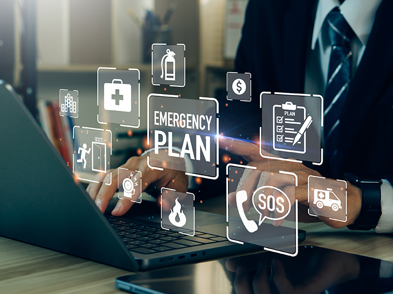 Laptop and person with digital graphic overlay of phrases and icons to do with emergency preparation