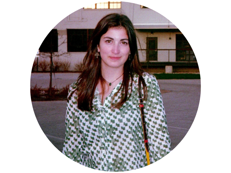 Ellie Farrell wearing a dress with a green and white diamond pattern, with a building a behind her
