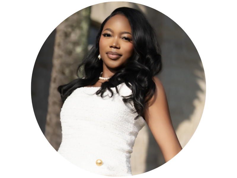 Madison Dunn wearing a white dress, leaning against a stone wall