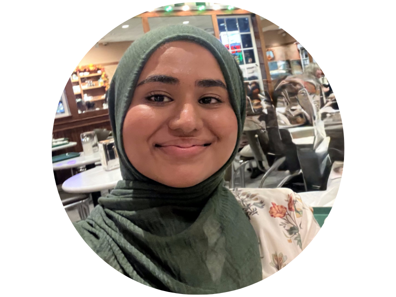 Roja Abas smiling, wearing a green hijab