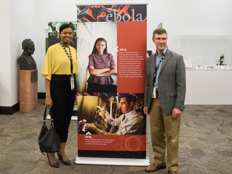 Dr. Adaora Okoli poses in front of an exhibit in "Outbreak"