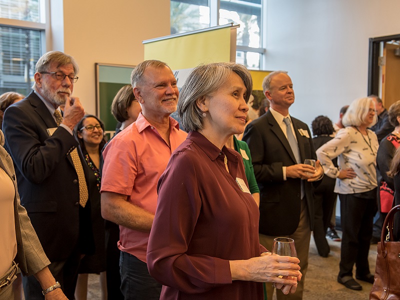 Visitors listen to speaker at Outbreak exhibit