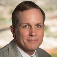 Brian Lucket, smiling, headshot, wearing a tie