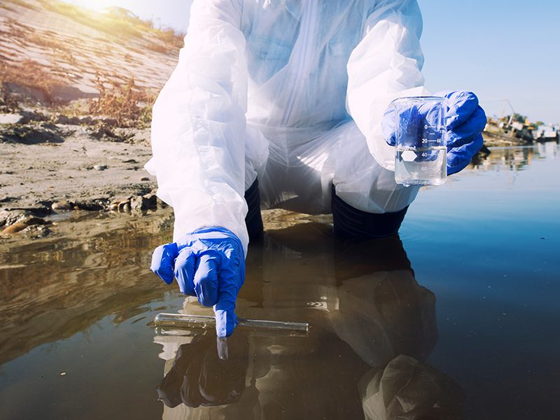 Photo of a person collecting water from a river.