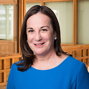 Libby ALexander, smiling, wearing a blue shirt