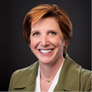 Nancy Messonnier, smiling, wearing a brown suit