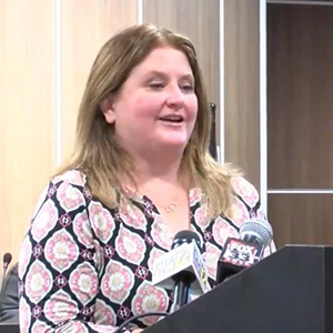 Martha Whyte, speaking at a podium