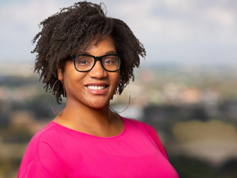 Caryn N. Bell, smiling at camera, headshot, wearing suit