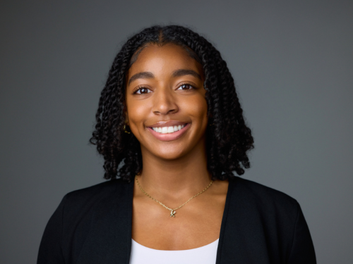 Kaia Todd smiling, wearing a black blazer.
