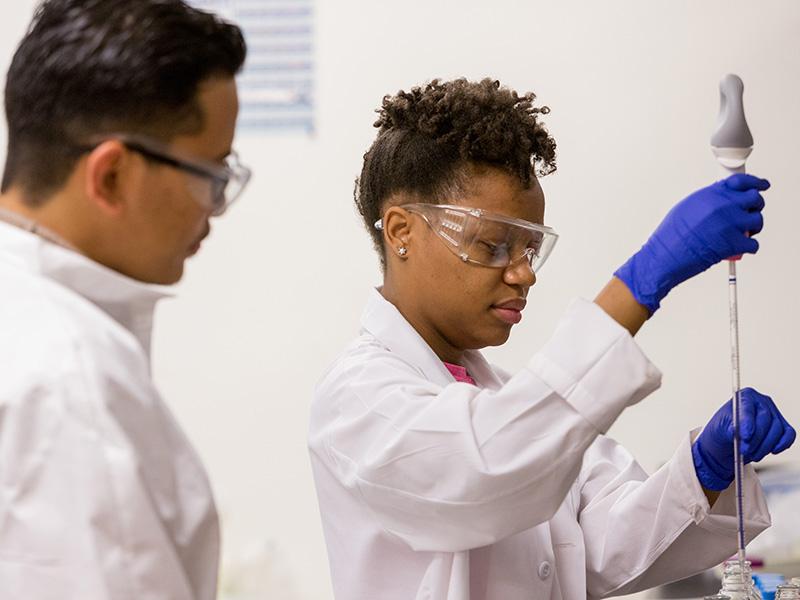 Student and instructor in global environmental health sciences lab