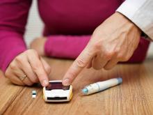 Doctor pointing to number on diabetes blood sugar monitoring device