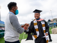 Alpha Phi Alpha member is 2021 MPH graduate, photo with friend