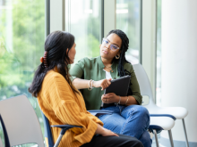 Two women discussing health work